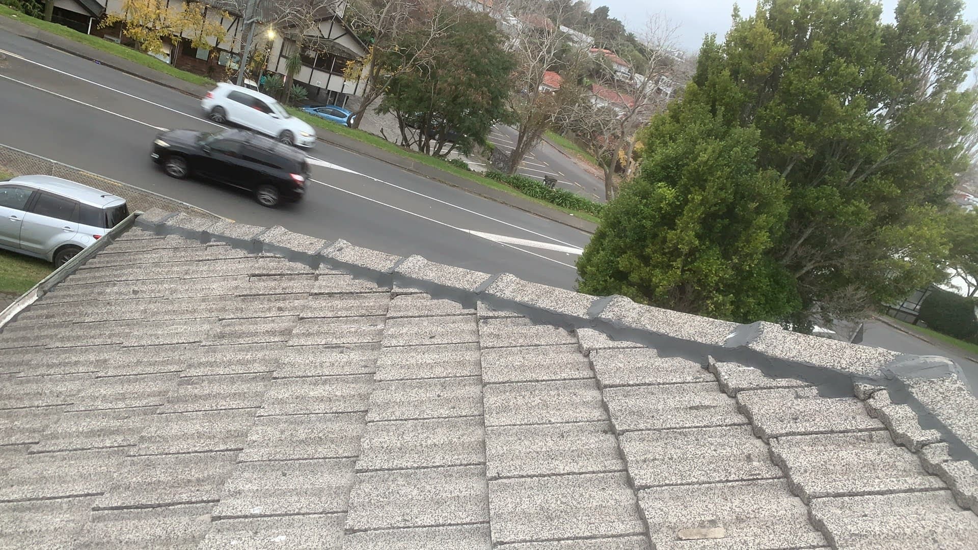 Concrete tile roof before respray — weathered grey surface showing years of exposure